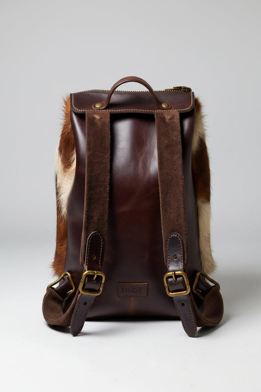Brown and beige cowhide backpack with leather strap